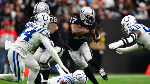 Nov 13, 2022; Paradise, Nevada, USA; Las Vegas Raiders wide receiver Davante Adams (17) runs the ball against Indianapolis Colts cornerback Kenny Moore II (23) defensive tackle DeForest Buckner (99) and linebacker Zaire Franklin (44) during the first half at Allegiant Stadium.